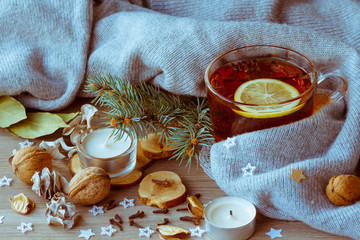 Cup of tea with spices and lemon in winter decoration
