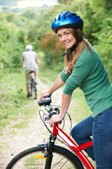 Young Couple Cycling Along Country Track
