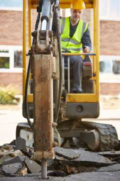 Construction Worker Operating Digger On Site