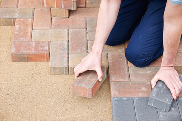 Man Laying Blocks For Patio
