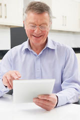 Fototapeta premium Senior Man Using Digital Tablet At Home