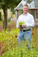 Senior Man Relaxing In Garden At Home