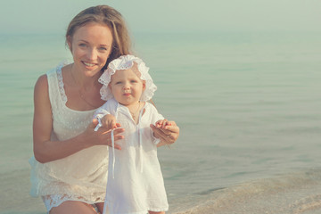 Mother and her daughter having fun on the beach