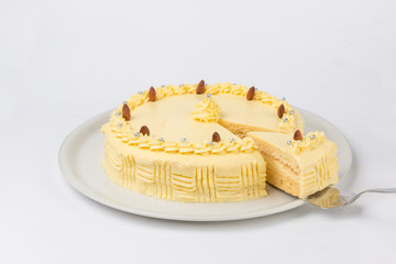 Homemade banana cake served on a white plate. Studio shot on white background