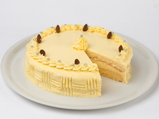 Homemade banana cake served on a white plate. Studio shot on white background