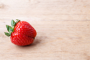 Red fresh strawberry fruit on wooden table.