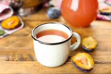 Plum Juice in jar and mug with fresh fruits