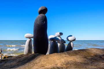 Black stone and group of white pebbles