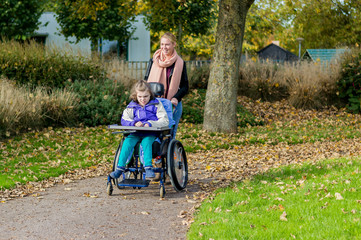 Disabled girl in a wheelchair relaxing outdoors / Disabled girl in a wheelchair relaxing outdoors...
