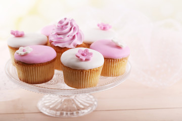 Tasty cupcake on stand, close-up