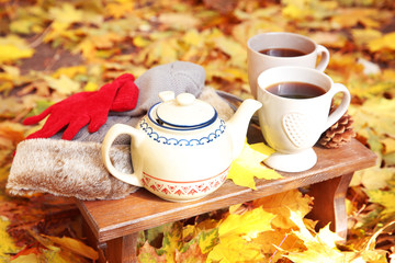 Naklejka na ściany i meble Autumn composition with hot beverage on nature background