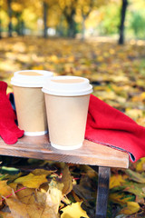 Autumn composition with hot beverage on nature background