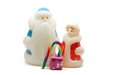 Ded Moroz and Snegurochka with gift box and sweets over white