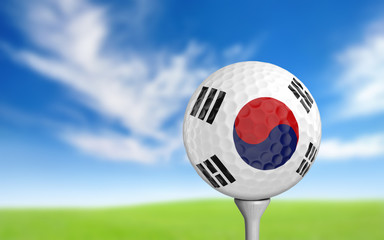 Golf ball with South Korea flag colors sitting on a tee