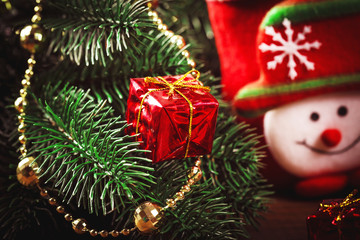 Christmas sock with toys and gifts on wooden background with Christmas tree