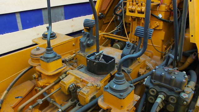 Yellow bulldozer with connections rubber and hoses