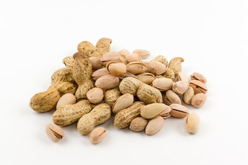 hill of a peanut and pistachios in a shell lies on a white backg