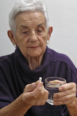 senior woman taking pills