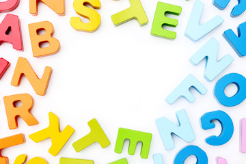A border of rainbow colored wooden alphabet blocks