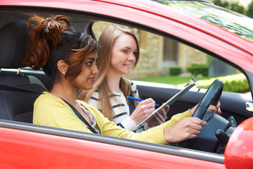 Young Woman Having Driving Lesson With Female Instructor