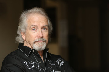 Portrait of a Shakespearian Actor, handsome mature male model with silver hair.