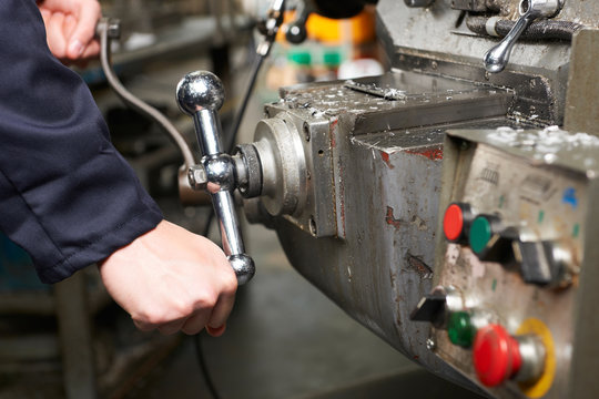 Detail Of Engineers Hands Operation Controls On Lathe