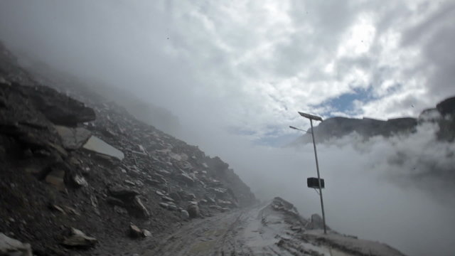 Bumpy ride on muddy earth road in Himalayas