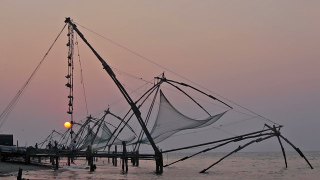 Chinese fishnets on sunset. Landmark and tourist attraction in Fort Kochin, Kochi, Kerala, India