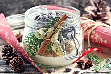Edible gift Idea: oatmeal cookies mix in the glass jar on a rustic wooden table.Selective focus