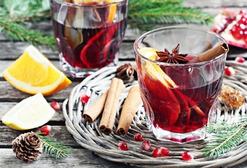 Mulled wine and spices on a rustic wooden table