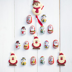 Chocolate Santas, Snowman and Biscuits laying in a form of Chris