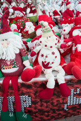 A lot of toy Santa Clauses, snowmen and deer on the Christmas  market