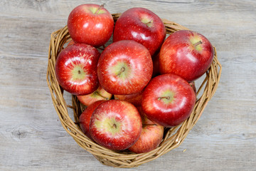 Red apples in a basket wicker
