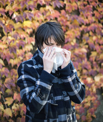 Young woman blowing her nose 
