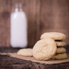 Sugar Cookies with jar of milk in background. Square format.