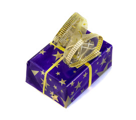 Gift box wrapped in blue paper with golden stars and sequin bow isolated over white with clipping path. Main colors are dark blue and  golden. Holidays and events theme.