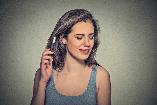 woman displeased on phone with headache. Upset unhappy girl talking on phone