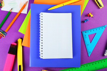 Office and student tools on purple background closeup