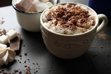 Cup of coffee with milk on a wooden table closeup