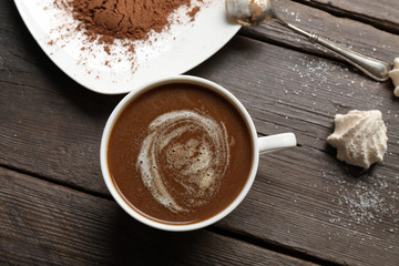 Cup of coffee with kisses on wooden background