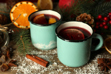 Obraz na płótnie Canvas Decorated composition of mulled wine in mugs on wooden table