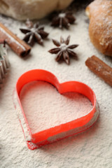 Heart of flour, croissant and spices on gray background