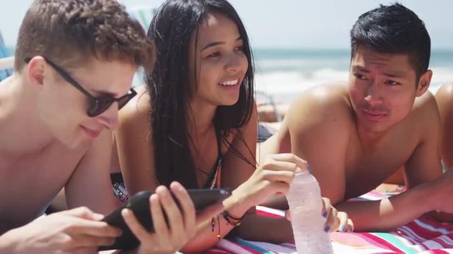 Portrait of young multi ethnic friends enjoying sunny beach