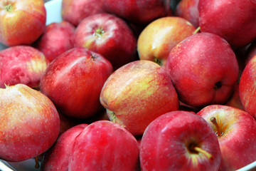 Fototapeta na wymiar Background of ripe juicy apples, close-up
