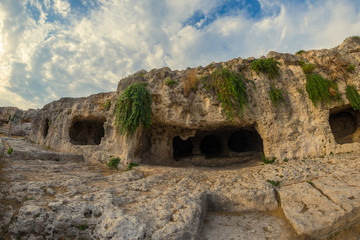Fototapeta na wymiar Caves located above the Greek Theatre, Neapolis Archaeological Park, Siracusa, Sicily, Italy