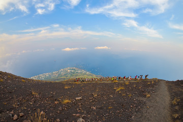Group of tourists hiking on top of the Stromboli Volcano in the Aeolian Islands, Sicily, Italy