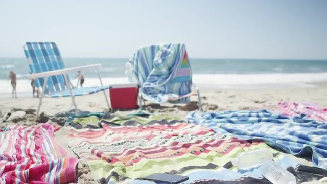Fun young group of  interracial friends running from beach shore