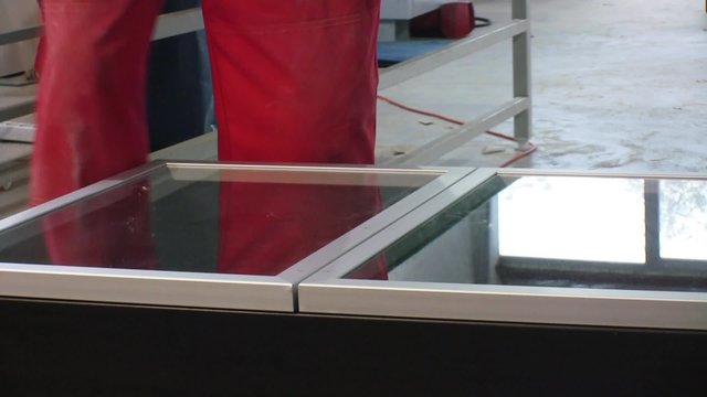 Worker assembling closet in furniture factory.
