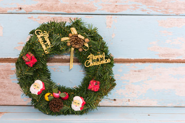 Christmas wreath decoration on grunge blue wooden background