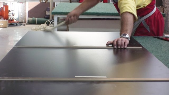 Worker assembling closet in furniture factory.
